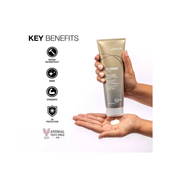 A person holding onto a bottle of lotion