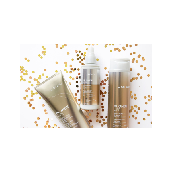 A group of three bottles on top of gold confetti.