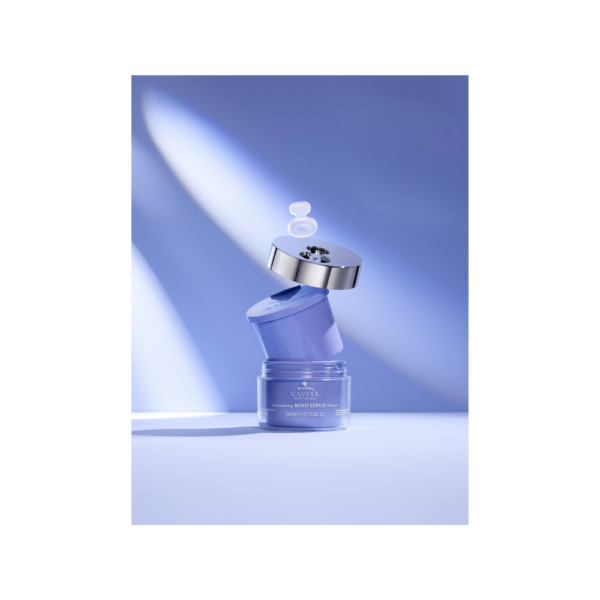 A blue bottle of lotion sitting on top of a table.