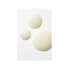 Three white balls of soap on a table.