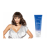 A woman in white shirt and blue top next to a tube of hair conditioner.