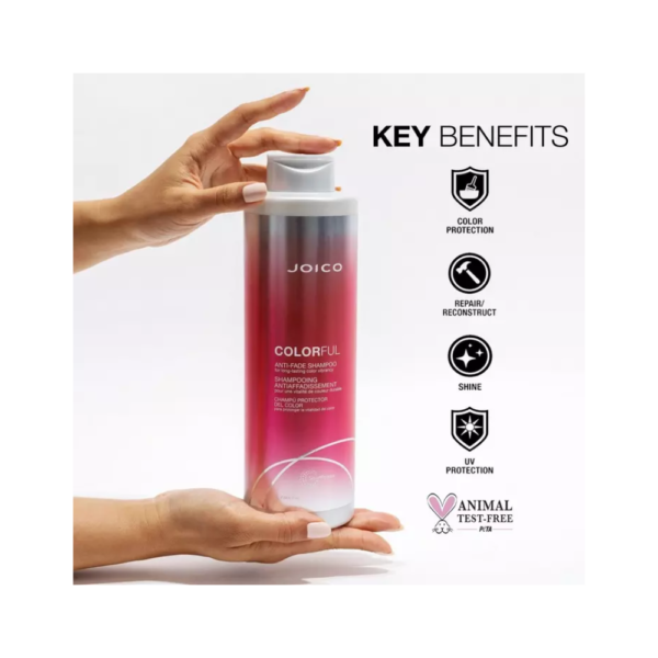 A person holding onto a bottle of hair conditioner