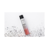 A bottle of makeup with silver glitter on it.