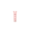 A pink tube of lotion sitting on top of a white table.