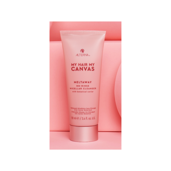 A tube of cream sitting on top of a pink box.