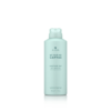 A bottle of hair conditioner on top of a white table.