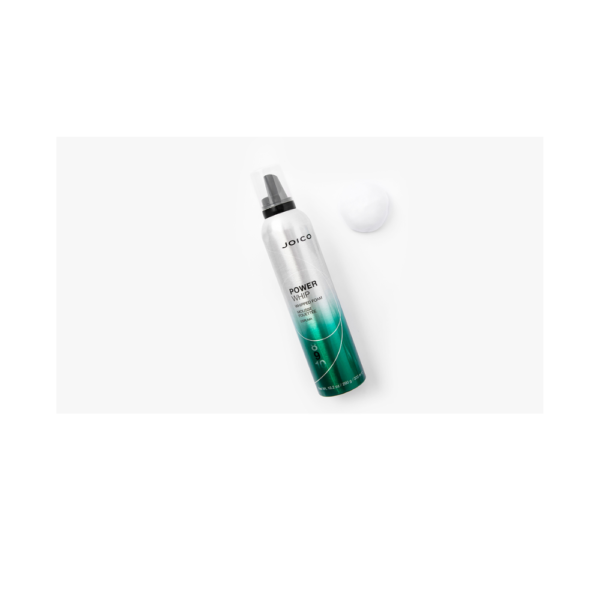 A green and white bottle of eye liner next to a ball.