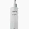 A bottle of hono body oil sitting on top of a table.