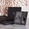 A box of chocolate with a black and silver design.