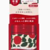 A red container with a floral design on it.